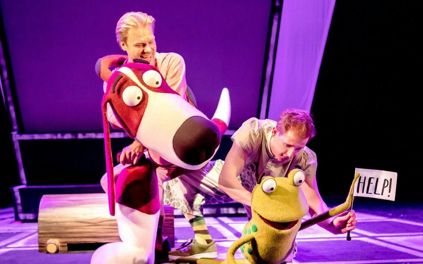 Actors performing with frog and dog puppets in "Oi Frog & Friends!" show.