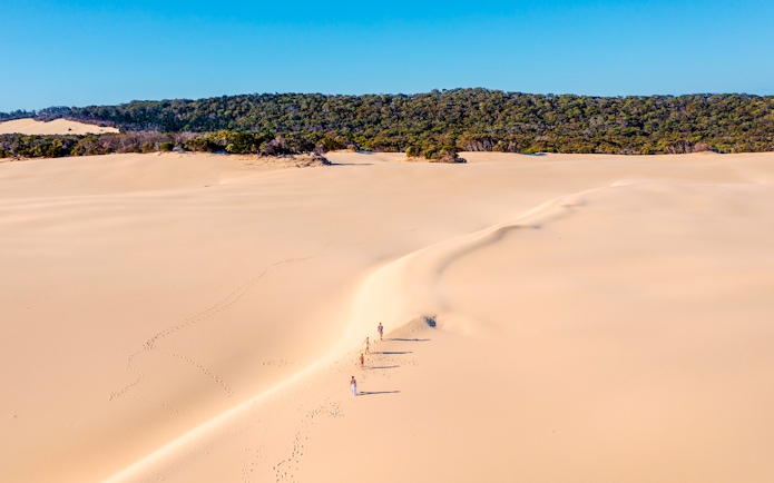 Aerial view of people walking on Hammerstone Sandblow, K'gari, Fraser Island.