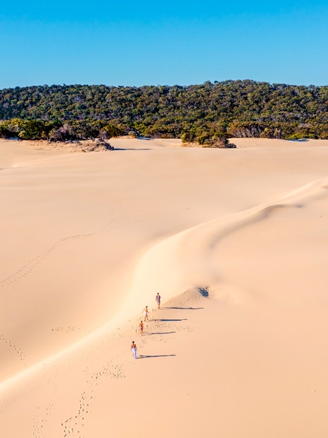 Aerial view of people walking on Hammerstone Sandblow, K'gari, Fraser Island.