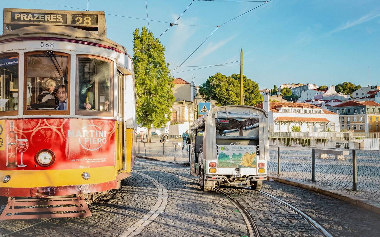Tuk-Tuk and Tram 28 on Lisbon street, showcasing eco tour route.