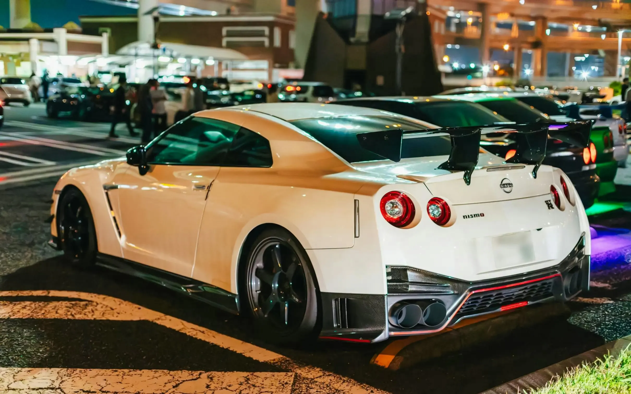 White sports car parked in Tokyo at night, part of Fast & Furious Tokyo Drift III Experience.