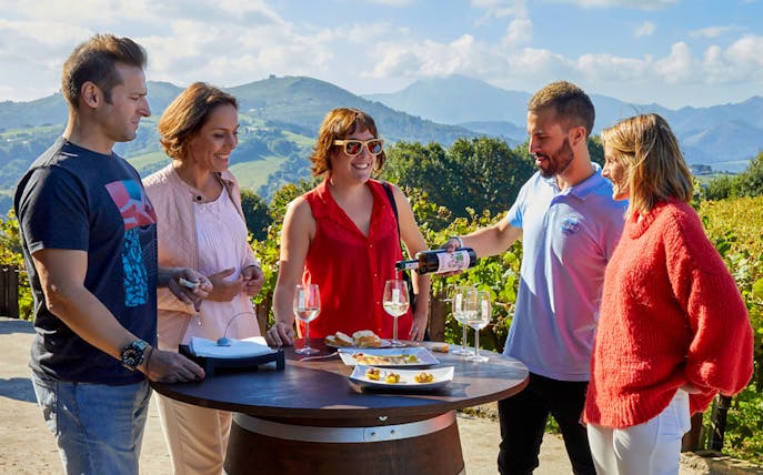Group enjoying wine tasting outdoors on Getaria Txakoli Guided Wine Tour.