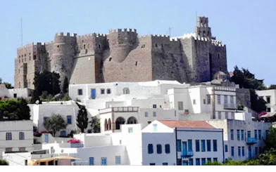 Akrotiri Venetian Castle overlooking white buildings in Santorini.