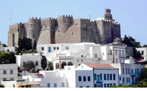 Akrotiri Venetian Castle overlooking white buildings in Santorini.