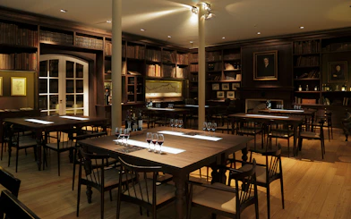 Graham’s Port Lodge tasting room with wine glasses on tables, Porto, Portugal.