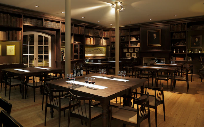 Graham’s Port Lodge tasting room with wine glasses on tables, Porto, Portugal.