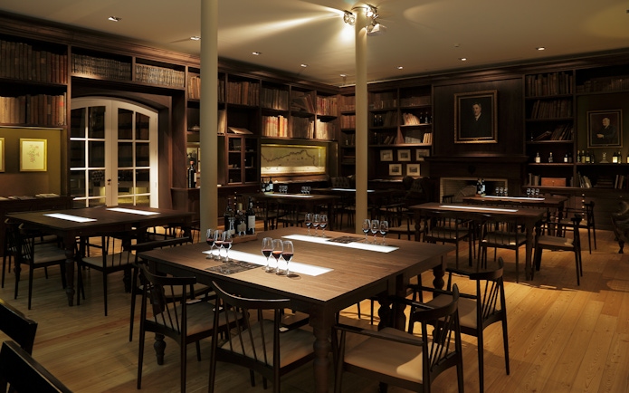 Graham’s Port Lodge tasting room with wine glasses on tables, Porto, Portugal.