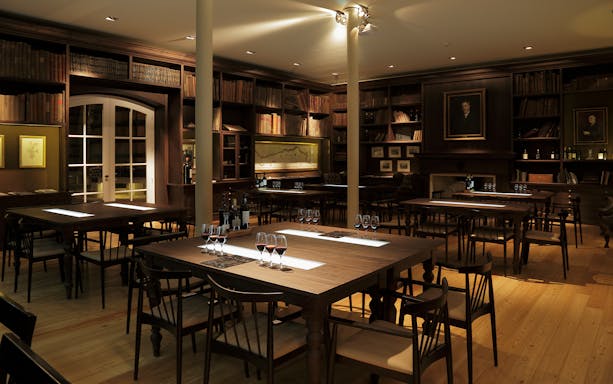 Graham’s Port Lodge tasting room with wine glasses on tables, Porto, Portugal.