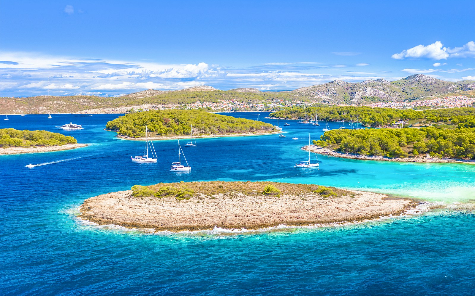 Aerial view of Pakleni Islands, Hvar, with sailboats near secluded Mlini Beach, Croatia.