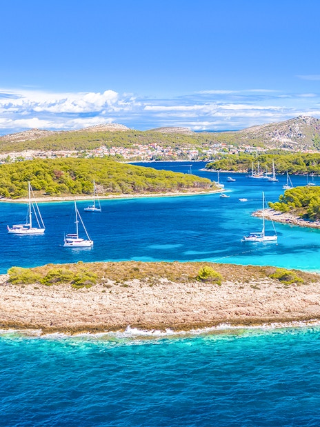 Aerial view of Pakleni Islands, Hvar, with sailboats near secluded Mlini Beach, Croatia.