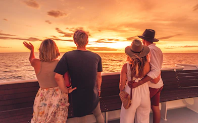 People enjoying a sunset view on a Darwin Harbour dinner cruise.