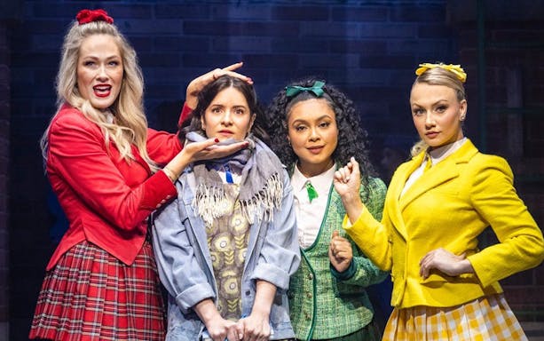 Cast members of Heathers the Musical on West End stage in colorful costumes.