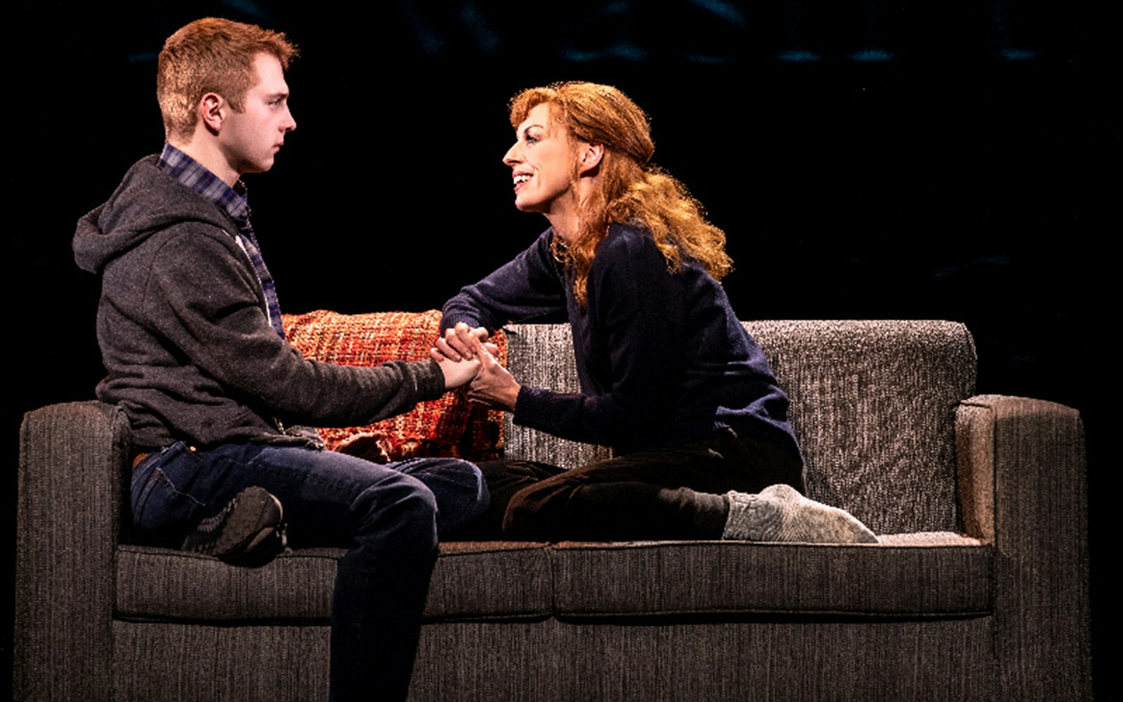 Two actors on a couch in a scene from Dear Evan Hansen musical.