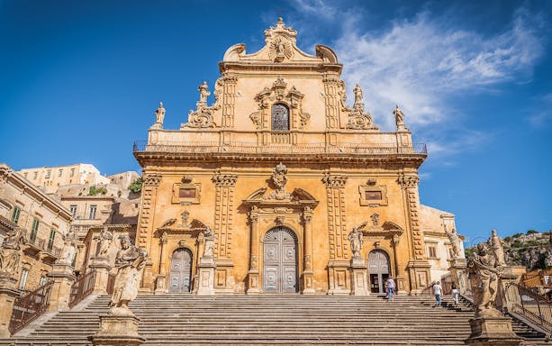 Cathedral of San Pietro facade with statues and steps, Modica, Sicily, Italy.