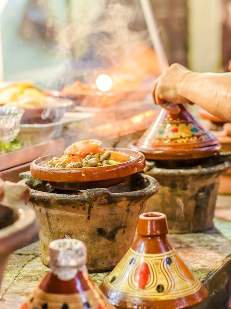 Tagines cooking at a street food stall in Jema el Fna, Marrakesh.