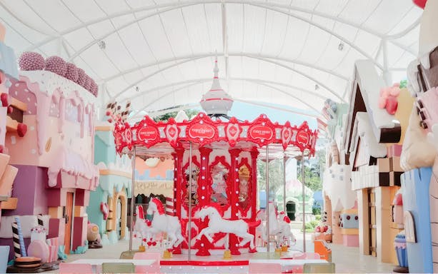 Carousel in Fairy Sweet Village with candy-themed buildings.