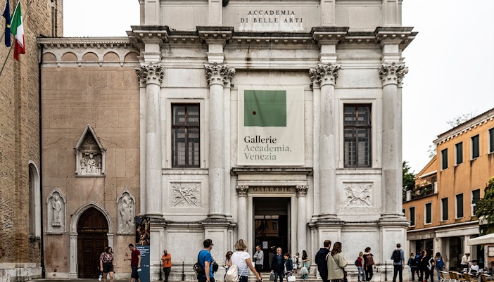 Visitors admiring Michelangelo's David statue at Accademia Gallery, Florence.