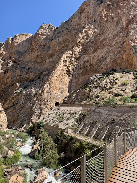 Caminito del Rey walkway through rocky gorge in Málaga, Spain, with river below.