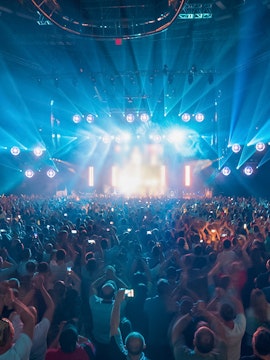Crowd enjoying a vibrant light show at Hi Ibiza nightclub.