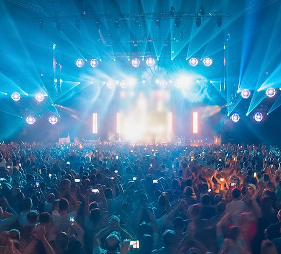 Crowd enjoying a vibrant light show at Hi Ibiza nightclub.
