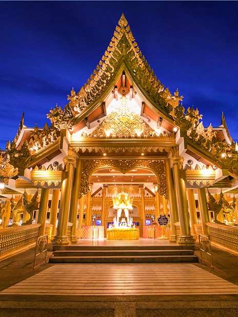 Phuket Fantasea entrance illuminated at night, featuring ornate golden architecture.