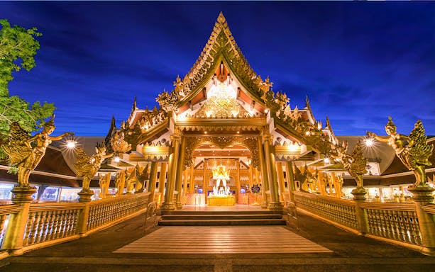 Phuket Fantasea entrance illuminated at night, featuring ornate golden architecture.