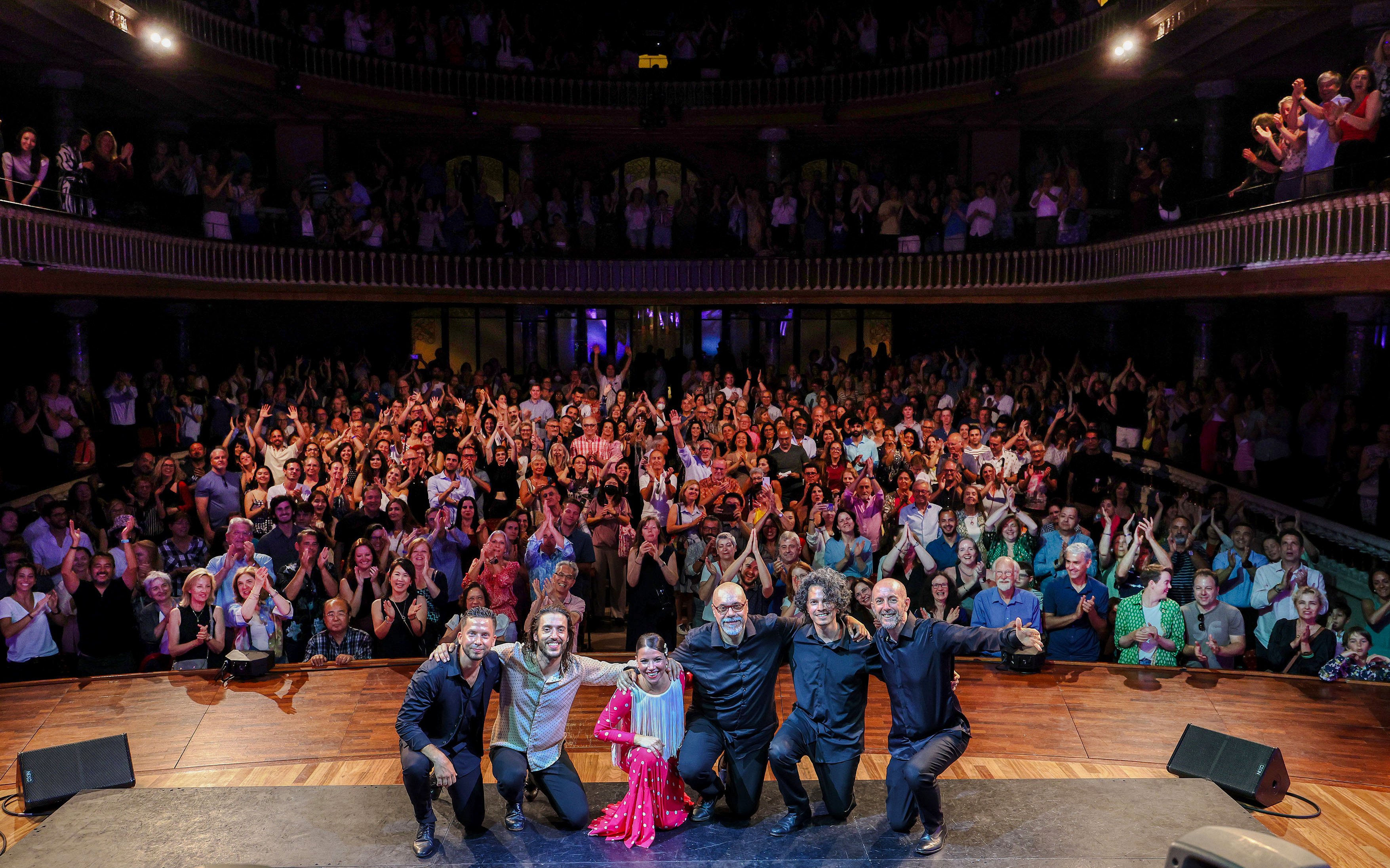 Flamenco artists pose on stage with audience at Barcelona Guitar Trio & Flamenco Dance.