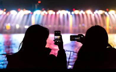 Silhouettes capturing Banpo Bridge rainbow fountain on Han River Marina Yacht.