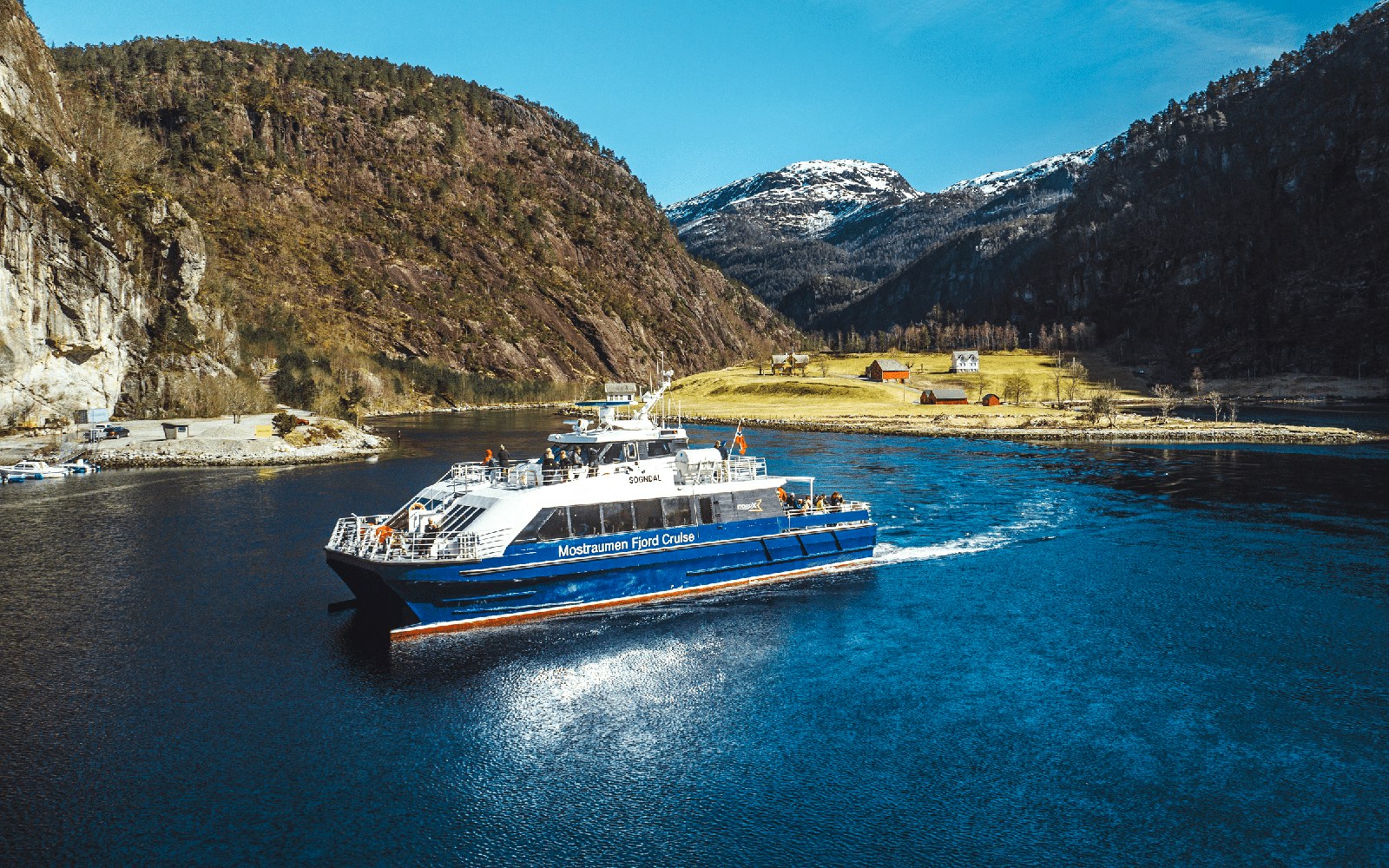 Mostraumen Fjord Cruise boat sailing through scenic fjord near Bergen, Norway.