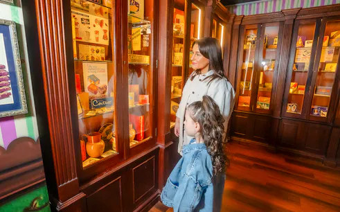 Guests viewing vintage Cadbury displays at Bourneville Experience, Cadbury World.