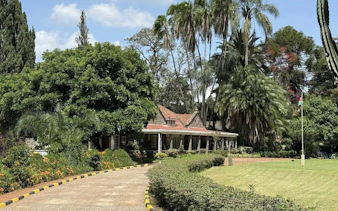 Karen Blixen Museum surrounded by lush gardens, part of the "Out of Africa" Original Farm Tour.