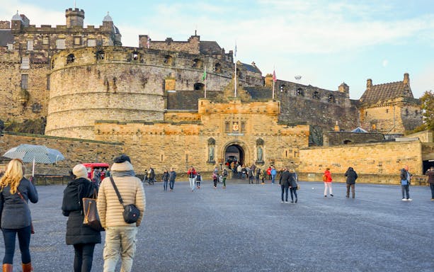 Visitors walking towards the Esplanade Entrance of Edinburgh Castle, Scotland.