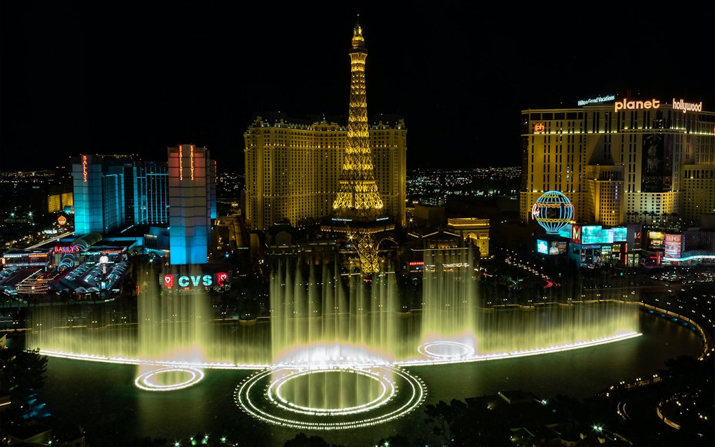 Eiffel Tower replica and Bellagio Fountains at night, Las Vegas Strip.