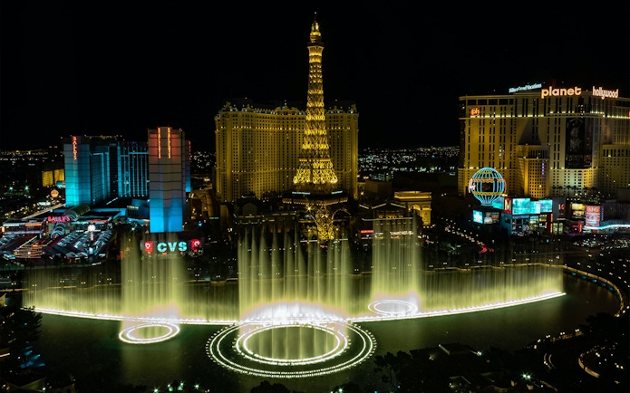 Eiffel Tower replica and Bellagio Fountains at night, Las Vegas Strip.