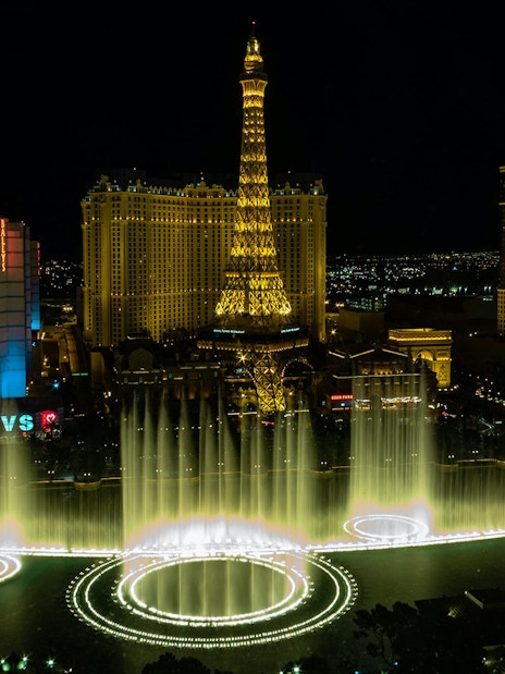 Eiffel Tower replica and Bellagio Fountains at night, Las Vegas Strip.