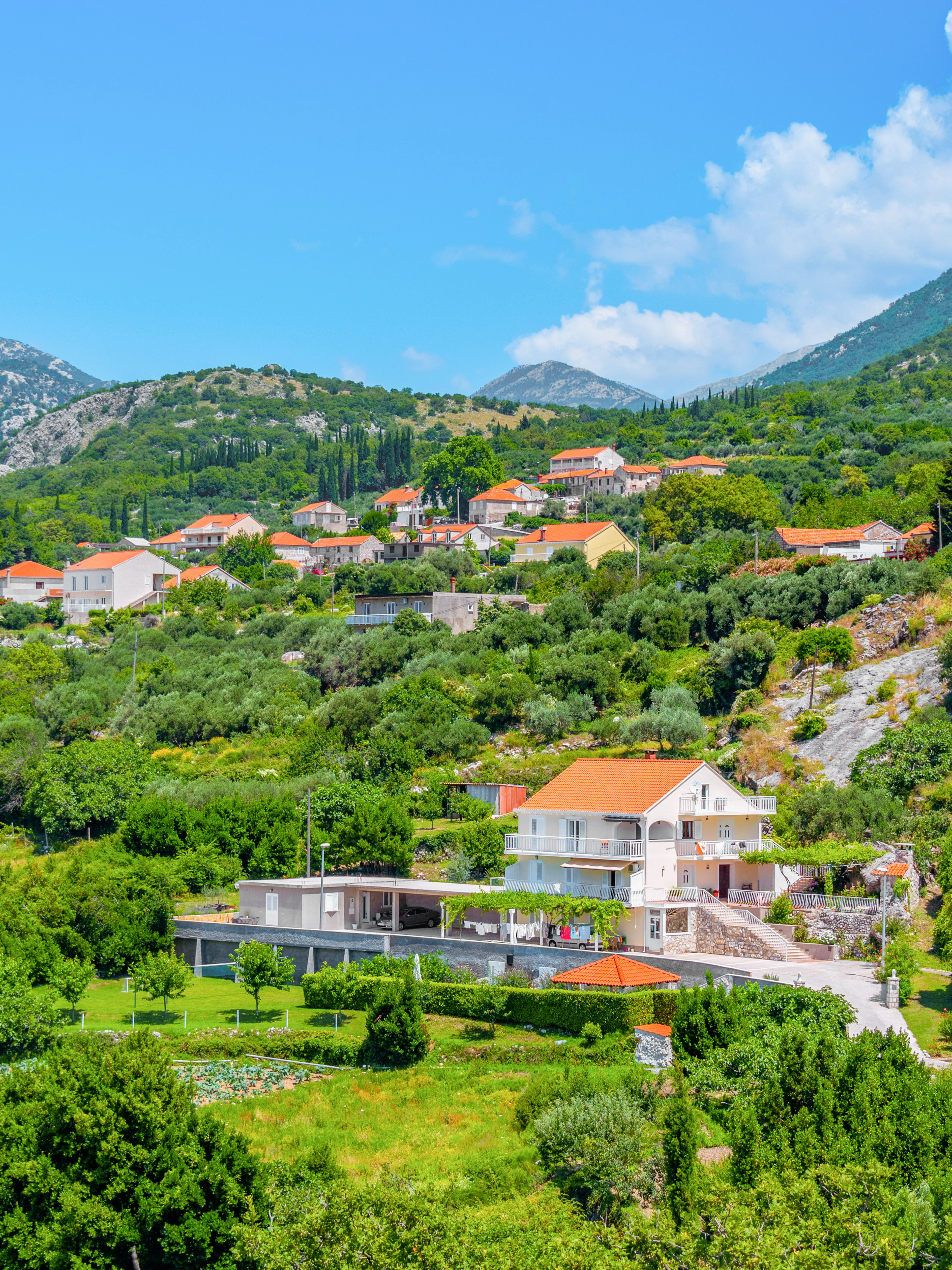 Hillside village with red-roofed houses in the Croatian countryside near Sokol fortress, Konavle.