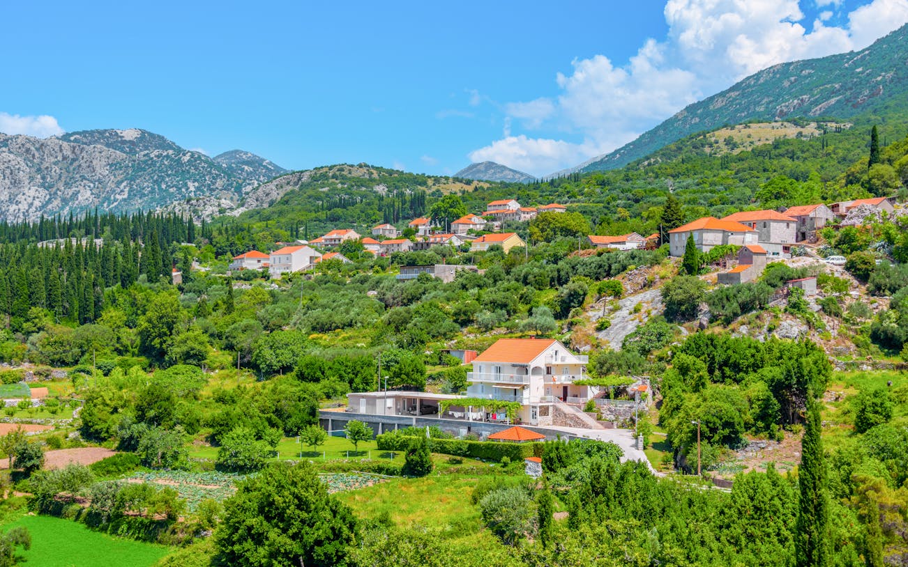 Hillside village with red-roofed houses in the Croatian countryside near Sokol fortress, Konavle.