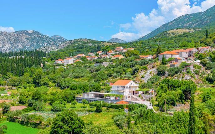 Hillside village with red-roofed houses in the Croatian countryside near Sokol fortress, Konavle.