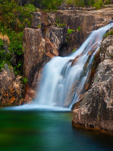 Waterfall cascading over rocks in Peneda Gerês National Park, Portugal.