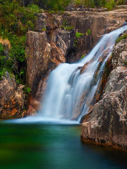 Waterfall cascading over rocks in Peneda Gerês National Park, Portugal.