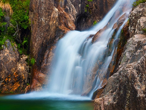 Waterfall cascading over rocks in Peneda Gerês National Park, Portugal.