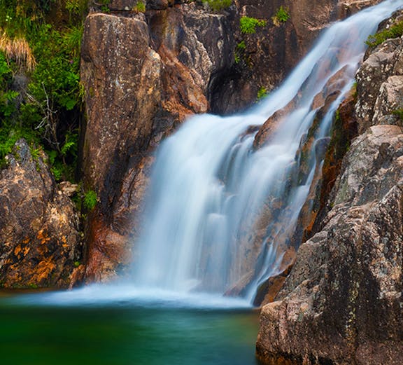 Waterfall cascading over rocks in Peneda Gerês National Park, Portugal.