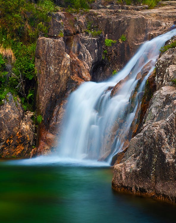 Waterfall cascading over rocks in Peneda Gerês National Park, Portugal.