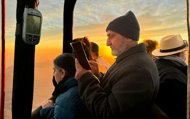 Hot air balloon passengers over Marrakech at sunrise.