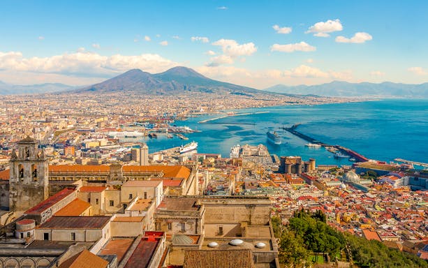 Naples cityscape with Mount Vesuvius and harbor, Italy.