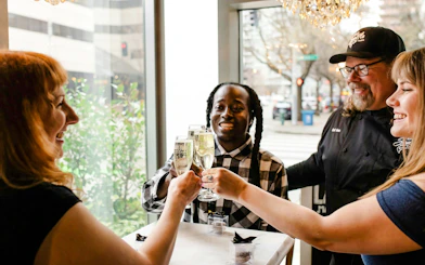 Group toasting with champagne during Seattle Happy Hour Tour.