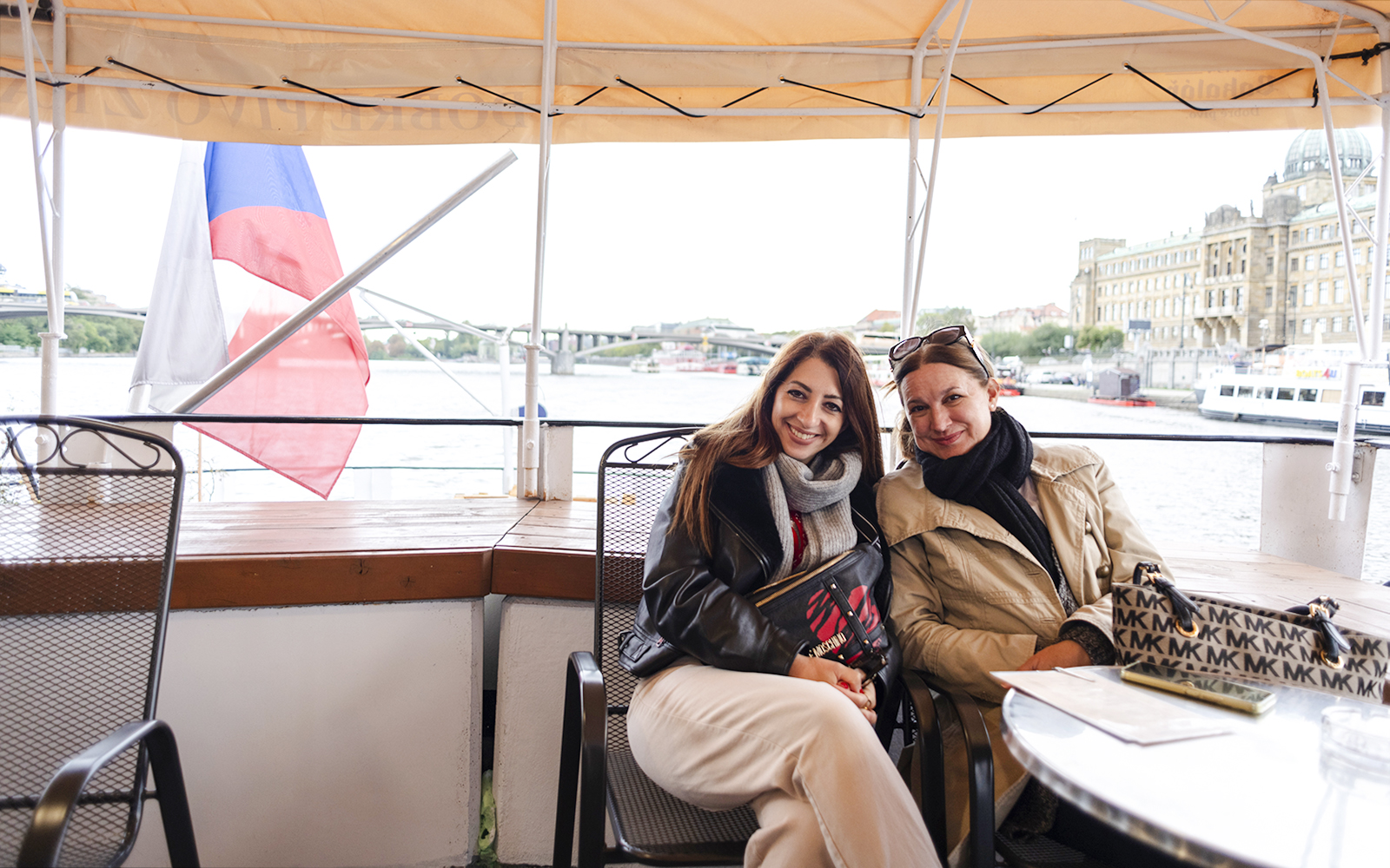 Tourists enjoying a sightseeing cruise on the Vltava River in Prague.