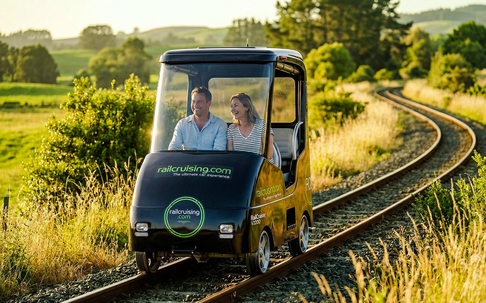 Couple enjoying a self-drive rail car journey on tracks through Ngongotaha countryside.