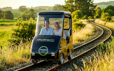 Couple enjoying a self-drive rail car journey on tracks through Ngongotaha countryside.