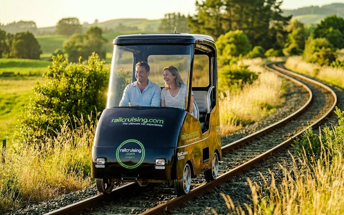 Couple enjoying a self-drive rail car journey on tracks through Ngongotaha countryside.